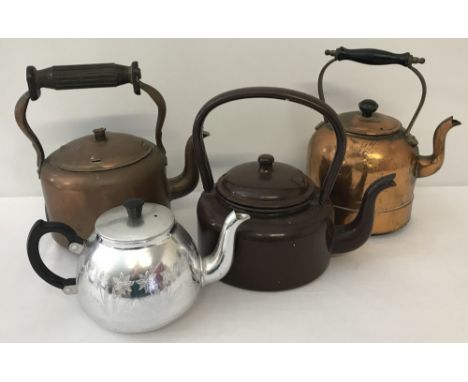 A small collection of metal ware teapots and kettles. Comprising; 2 vintage wooden handled copper kettles, an enamel teapot a