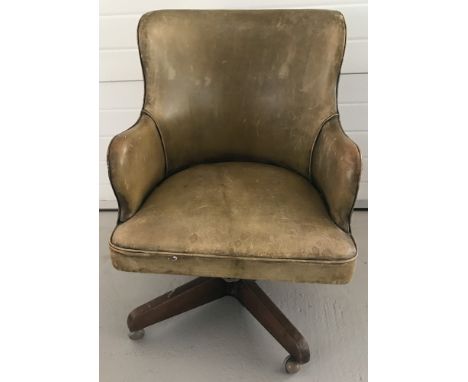 A vintage leather swivel desk chair with stud work to back and arms and wooden pedestal base.  