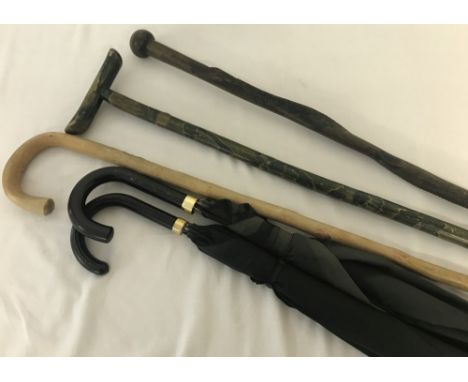 A small collection of vintage walking sticks and umbrellas. To include a Sir Jefferey Hillpig Smyth Burmese Army Trekking sti