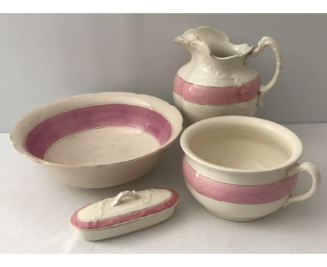 A late 19th/early 20th century 4 piece ceramic wash set in pink and cream. Comprising: large jug &amp; bowl, long oval lidded