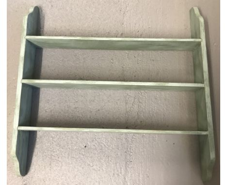 A vintage wooden wall hanging shelf painted pale green.  Approx. 69cm x 68cm.