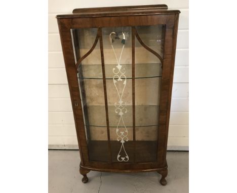 A small vintage glass display cabinet with glass door and side panels on small cabriole legs. Feather edged banding and metal