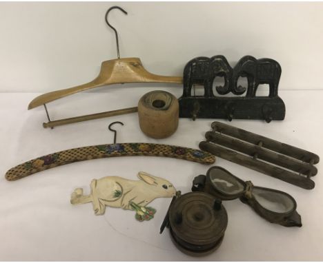 A collection of mixed items to include vintage goggles. A variety of treen objects, including a fishing reel and vintage coat