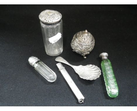 AN EASTERN WHITE METAL PEPPERETTE, decorated with embossed scrolling leaves, a silver caddy spoon, two silver topped cut glas