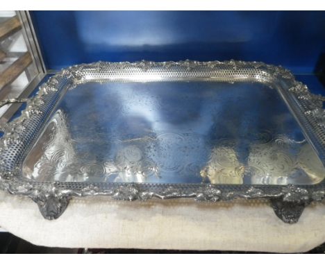 A LARGE SILVER PLATED TRAY of rectangular form, with grape and vine leaf decoration, 74.5cm wide 