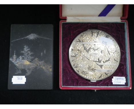 A JAPANESE SILVER GILT COMPACT decorated with blossoming flowers and peacocks, in fitted presentation case and a Japanese met