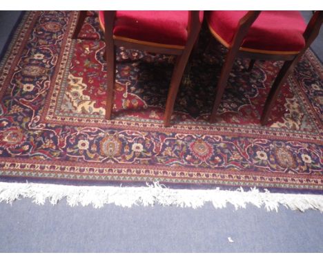 A RED GROUND PERSIAN DESIGN CARPET with central medallion and allover floral decoration, 200cm x 297cm (plus fringes) 