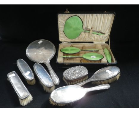 A FOUR PIECE SILVER AND GUILLOCHE ENAMEL DRESSING TABLE SET, comprising three brushes and a hand mirror in fitted presentatio