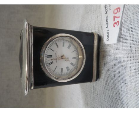 ASPREY: An Edwardian tortoiseshell and silver mounted travelling clock, circular white enamel dial with black Roman numerals,