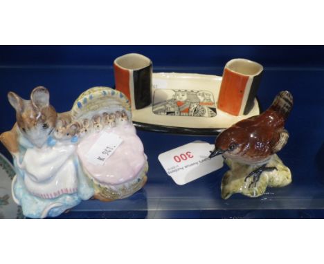 A ROYAL DOULTON MATCH STICK HOLDER, decorated with the King of hearts, a Beswick 'Hunca Munca' (gold label) and a Beswick Wre