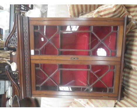 AN EDWARDIAN CHIPPENDALE REVIVAL HANGING GLAZED CABINET with pierced broken pediment and blind fret, 68cm wide  