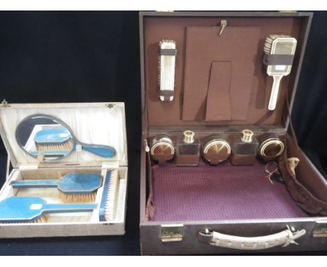 AN ART DECO PART VANITY SET, comprising two brushes, five bottles and mirror in brown fitted leather case and a Art Deco four