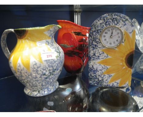 POOLE POTTERY; A SUNFLOWER, 'VINCENT' CLOCK, 23cm high, a similar jug and an African sky jug, (3) 