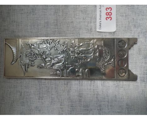 A CHINESE SILVER PLAQUE OR SCROLL WEIGHT, decorated with figures in a garden with pagodas and blossoming flowers, character m