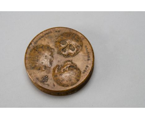 An early 19th Century treen Phrenology Patch Box 'Cranologie du Docteur Gall', the lid embossed with diagrammatic skulls, the