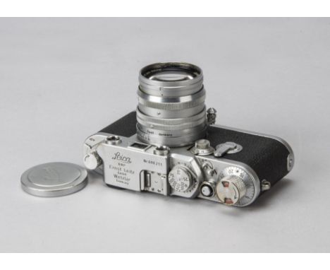 A Leica IIIf Red Dial Delayed Action Camera, serial no. 686211, chrome, shutter working, 1954, body F-G, age related marks to