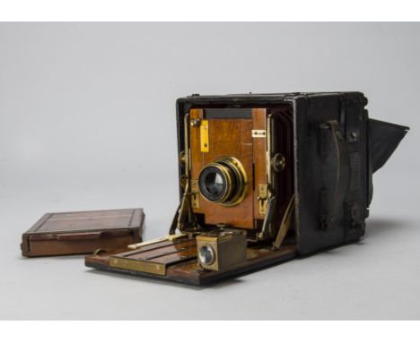 A Houghton Sanderson Hand and Stand Camera,  quarter-plate, mahogany and brass, red leather square tapered bellows, Sanderson