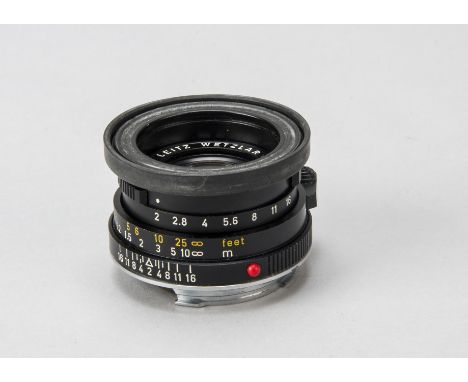 A Leitz Summicron-C f/2 40mm Lens,   serial no. 2979516, black, with 42519 rubber hood, lens bubble and maker's cap, barrel, 