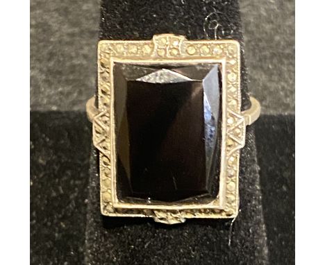 Art Deco silver and onyx ring, surrounded by marcasite stones.  Onyx stone measures approx 1.5cm by 1cm. All marcasites prese