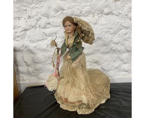 Automaton Antique Doll circa early 20th Century  Bisque doll with fixed eyes. With key in working order with twisting head an