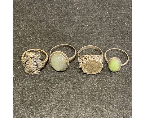 Four vintage silver rings. A silver and moss agate ring Size S. Needs soldering near the mount. Silver mounted three penny bi