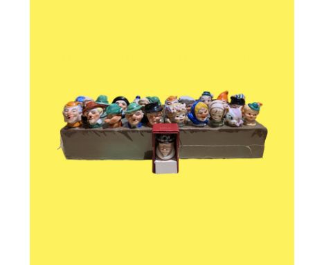 Twenty-four ceramic bottle stoppers and pourers Including Hummel and Wade. All in nice condition.