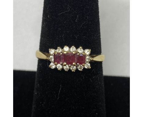 18ct Ruby and Diamond ring. Featuring 3 square cut rubies surrounded by diamonds. Total weight 3.78g Size O Lovely condition.