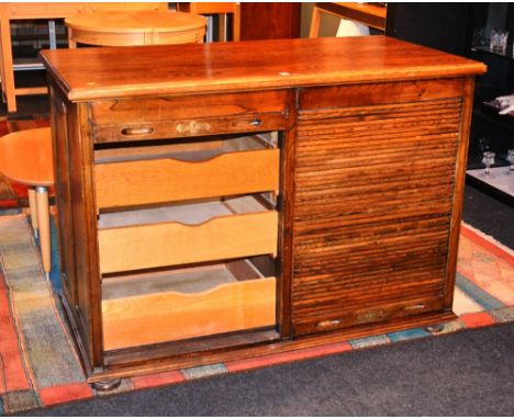 An oak tambour fronted chest of drawers, with two tambour roller shutters enclosing two banks of three drawers, 91cm high x 1