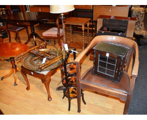 An Eastern brass top table, on folding stand, 57cm diameter, together with a folding penwork cakestand, an oak open armchair,