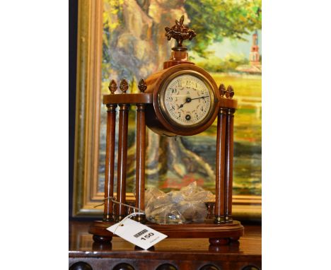A French Corinthian style mahogany Portico mantle clock, with cream enamel dial bearing Arabic numerals, 31cm high CONDITION 