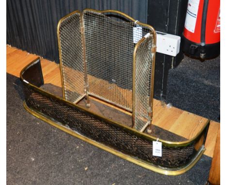 A pierced brass fire fender, 19cm high x 96cm wide, with a similar firescreen (2)