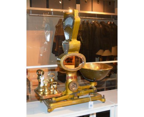 A vintage set of automatic shop scales, 80cm high, with four graduated brass coated weights