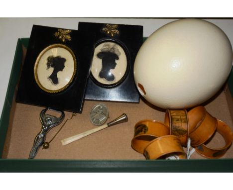 A quantity of collectables, to include five Mauchline ware napkin rings, an ostrich egg, two Regency style portrait silhouett
