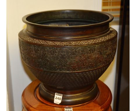 A Japanese bronzed planter, of urn shape with foliate decoration, ending in circular foot, 25cm high