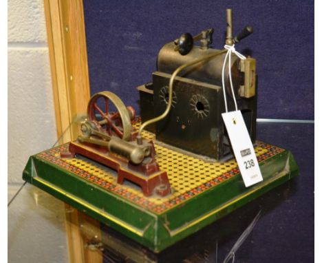 A vintage tin plate toy stationary engine, raised on painted square shaped tin plate base, 20.5cm diameter