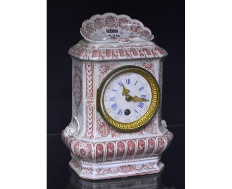 An early 20th century red and white ceramic mantle clock, with white enamel dial, Roman numerals and Arabic seconds chapter r