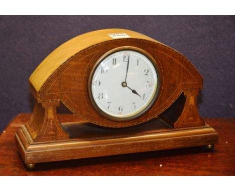 An Edwardian mahogany inlaid mantle clock, with French movement, white enamel circular dial, inlaid with stylized flowerheads
