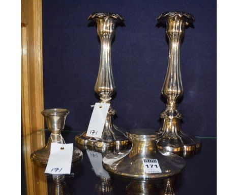A silver inkwell, the hinged lid enclosing ceramic insert, 12cm diameter, together with a small Birmingham silver candlestick