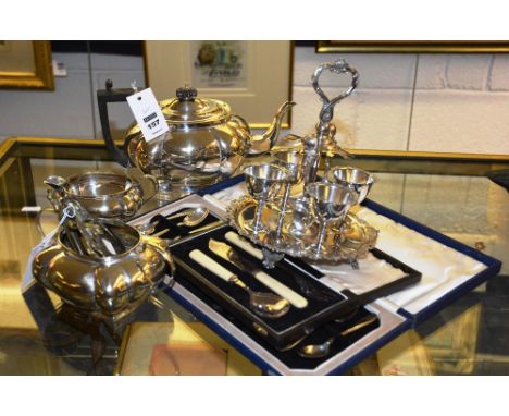 A silver plated tea service, comprising of teapot, sugar and cream, together with a yellow metal locket on chain, and a small