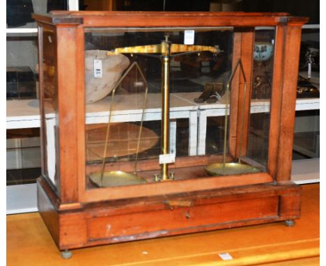 A set of vintage balance scales, in fitted wooden case with glazed pull up front, 56cm high x 63cm wide
