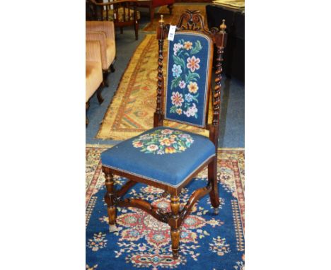 A mahogany hall chair, with floral needlepoint tapestry back rest and seat, decorated with barley twist columns, raised on tu