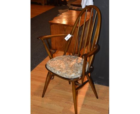 An Ercol open armchair, decorated with spindle supports, 96cm high x 61cm wide