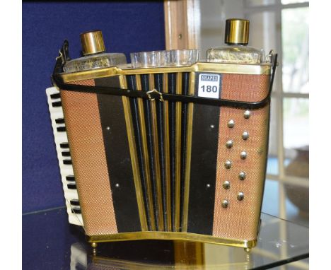 A novelty Tantalus, modelled as an accordion, with two decanters and four glasses, with wind up mechanism
