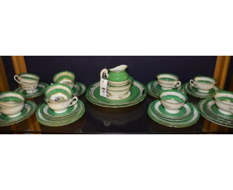 An early 20th century porcelain tea service, possibly by Wileman & Co, decorated with birds in foliage on white ground with g
