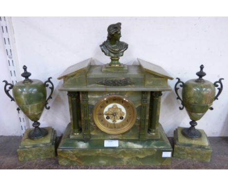 A brass and onyx clock garniture 