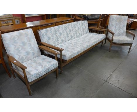 A Guy Rogers teak and fabric upholstered Manhattan range three piece lounge suite, comprising settee/daybed and a pair of arm