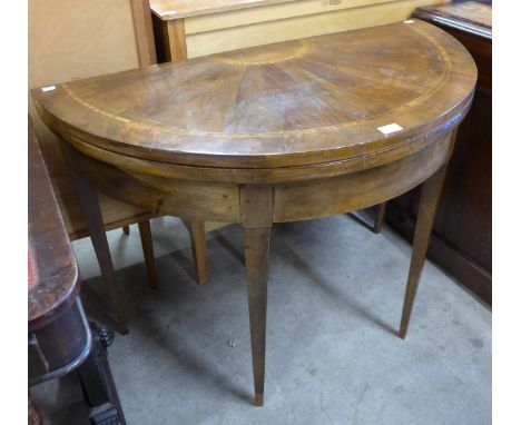 A George III inlaid walnut demi-lune fold over card table 