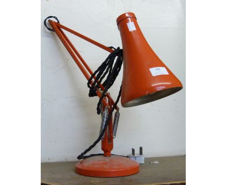 A red metal anglepoise desk lamp 