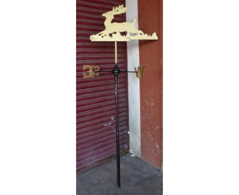 A cast iron painted deer topped weather vane 