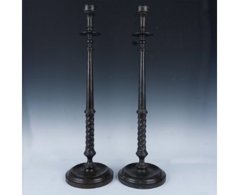 Bronze floor holders with round heavy base. Maitland Smith tag. Issued: 20th centuryDimensions: 30"H x 8.5" dia. Manufacturer